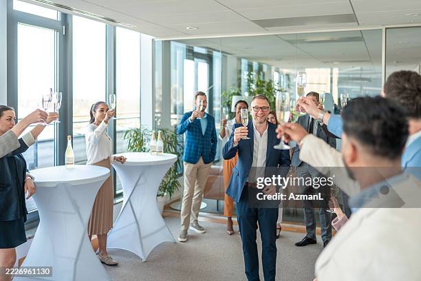 business professionals raising champagne glasses in office celebration - honour board stock pictures, royalty-free photos & images