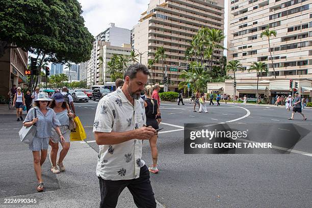 Man checks his mobile phone in Oahu, Hawaii on July 29 after an 8.7 earthquake off of Russia's far east prompted tsunami alerts. A powerful 8.7...
