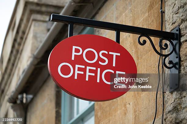 General view of an old fashioned style Post Office sign on the High Street on July 22, 2025 in Burford, United Kingdom.