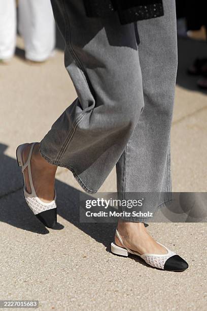 Guest, attending the Chanel Haute Couture Fall/Winter 2025/2026 show as part of Paris Fashion Week, is seen wearing a pair of light grey wide-leg...