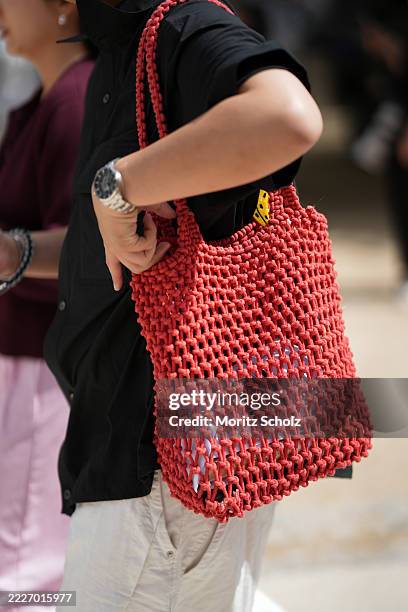 Guest, attending the Chanel Haute Couture Fall/Winter 2025/2026 show as part of Paris Fashion Week, is seen wearing a black short-sleeve button-up...