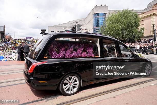 The hearse carrying the body of Ozzy Osbourne is seen near the Black Sabbath Bridge bench on Broad Street in Birmingham, as the Black Sabbath...