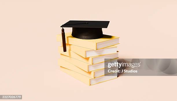 stack of blank yellow books topped with graduation cap – knowledge and academic achievement concept - diploma stock pictures, royalty-free photos & images