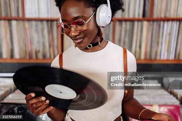 woman shopping records - record store stock pictures, royalty-free photos & images