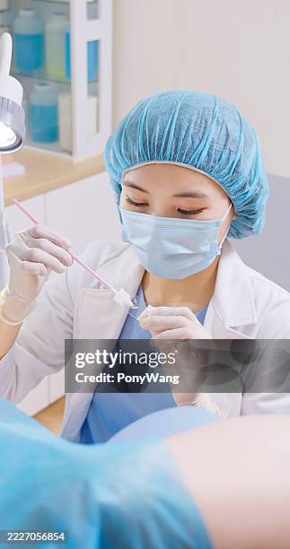 asian obgyn perform pap smear female patient - colposcopy stock pictures, royalty-free photos & images
