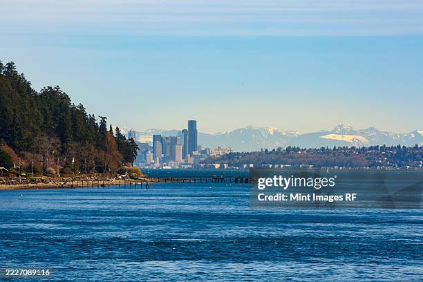 seattle skyline from the south end of bainbridge island and rich passage, washington - puget sound stock pictures, royalty-free photos & images