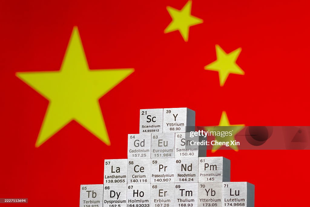 Rare earth element cubes stacked in front of Chinese flag