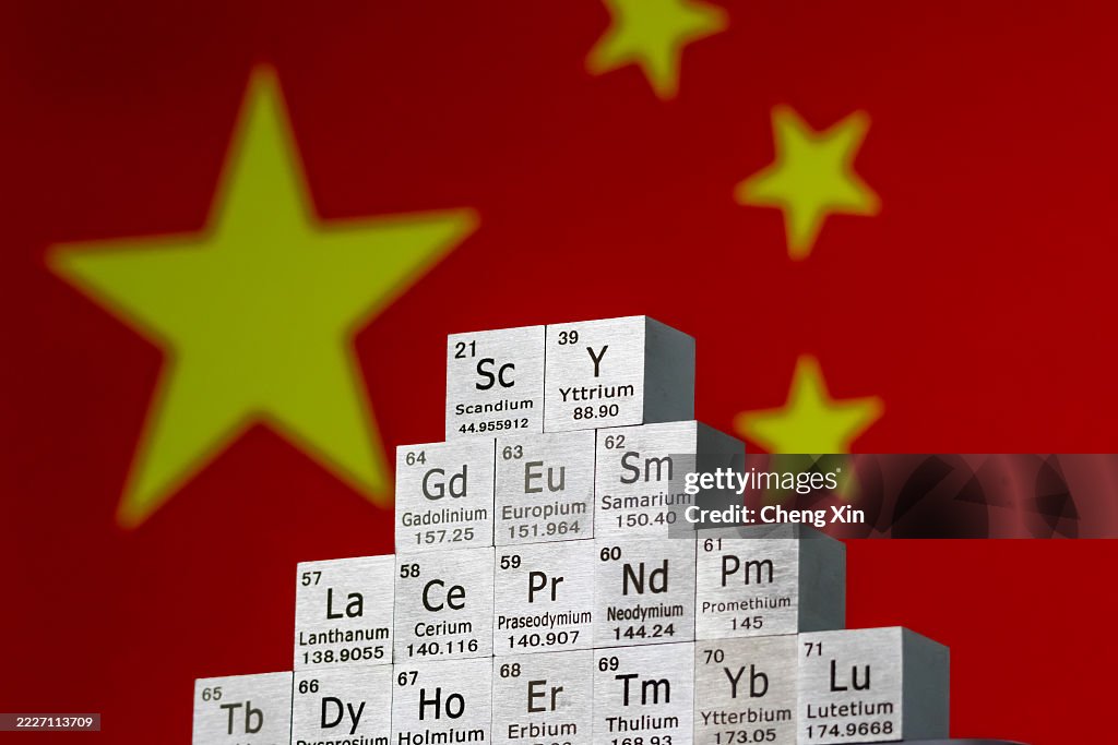 Rare earth element cubes stacked in front of Chinese national flag