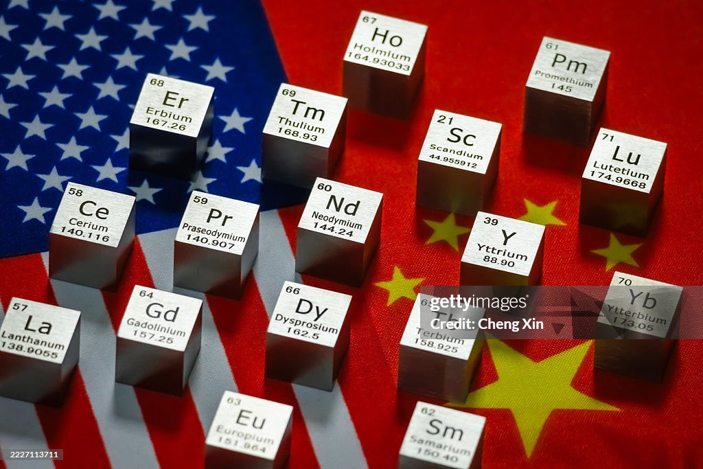 Rare earth element metal cubes displayed on U.S. and China flags