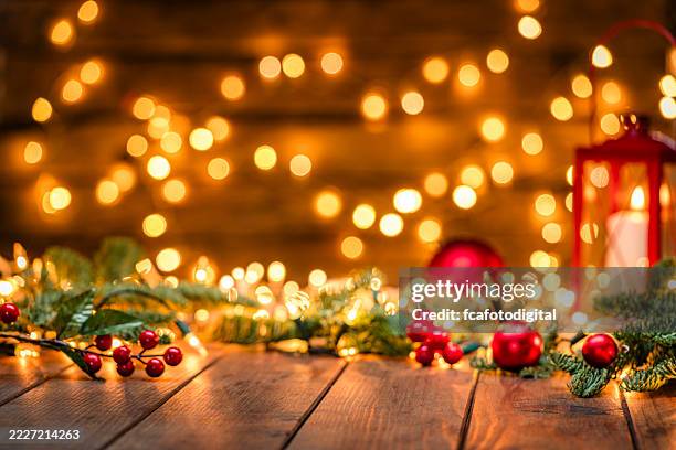 christmas backgrounds: glowing lights, decoration, fir tree, burning lantern, warm tones or gold colors. cozy december atmosphere, spirituality and tradition. focus on foreground - julbelysning bildbanksfoton och bilder