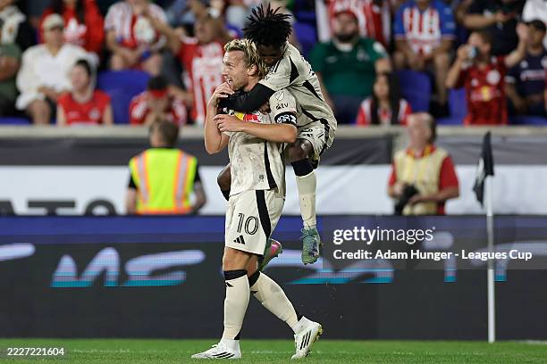 Emil Forsberg of New York Red Bulls is congratulated by Mohammed Sofo after scoring the team's first goal during the Leagues Cup Phase One match...