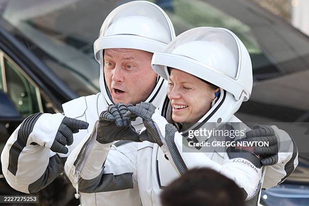 Crew-11 mission members NASA astronaut Mike Fincke and NASA astronaut and mission commander Zena Cardman gesture to family and supporters as they...