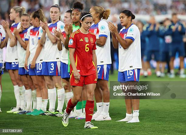 Aitana Bonmati of Spain looks dejected as she walks through a guard of honour formed by players of England after England defeat Spain in a penalty...