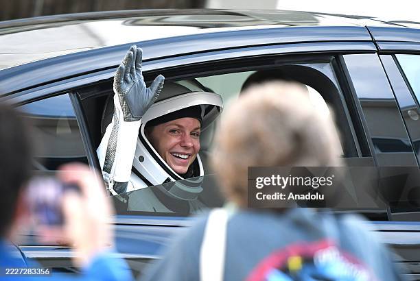 Astronaut and mission commander Zena Cardman waves to family members outside the Neil A. Armstrong Operations and Checkout Building before heading to...
