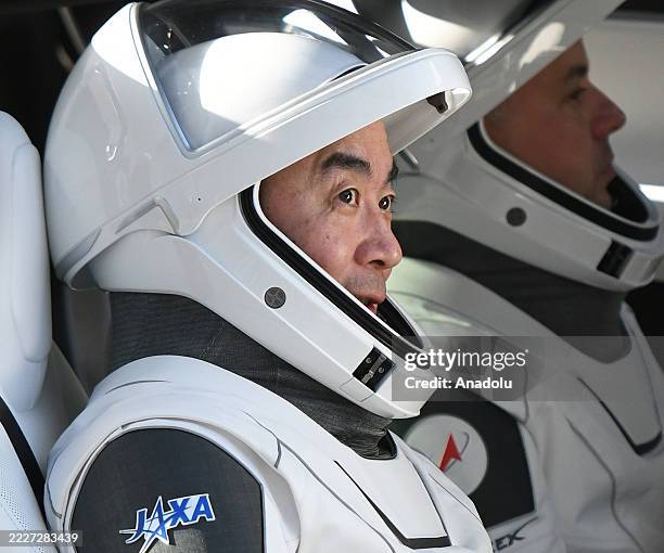 Astronaut Kimiya Yui waits to depart after greeting family members outside the Neil A. Armstrong Operations and Checkout Building before heading to...