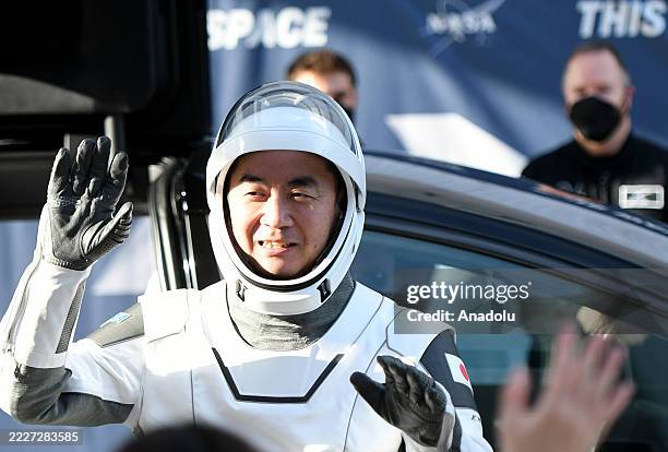 Astronaut Kimiya Yui waves to family members outside the Neil A. Armstrong Operations and Checkout Building before heading to pad 39A for launch to...