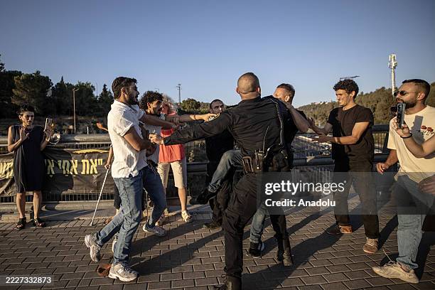Protesters hold a demonstration at the entrance of the Abu Ghosh near East Jerusalem on August 1 in solidarity with Gaza amid ongoing Israeli attacks...