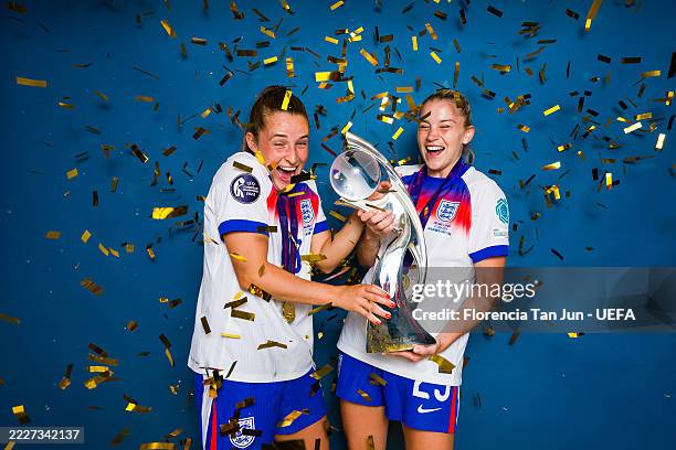 Ella Toone and Alessia Russo of England pose for a portrait with the UEFA Women's EURO trophy after England defeat Spain 3-1 in a penalty shootout to...