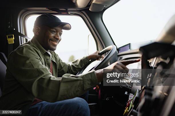 truck driver using gps navigation system while driving - location tracking stock pictures, royalty-free photos & images