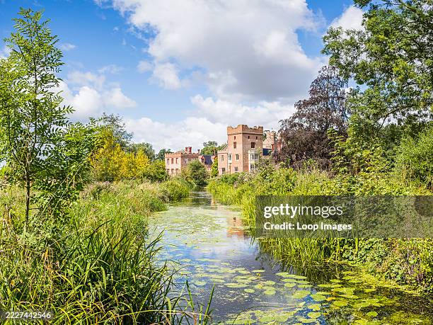 Oxburgh Hall over a channel of water.