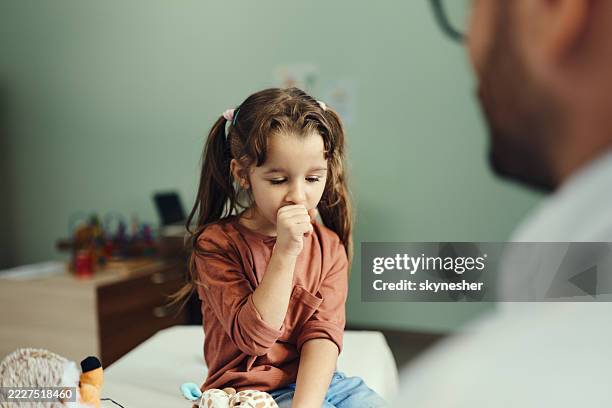 small girl coughing on appointment at doctor's office. - paramedic patient stock pictures, royalty-free photos & images