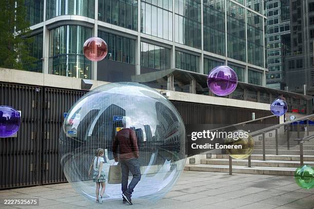 people inside glass spheres in the street - infectious disease stock pictures, royalty-free photos & images
