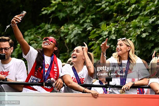 Khiara Keating, Georgia Stanway and Chloe Kelly of England take a selfie during the England Women's team victory parade and celebration on July 29,...