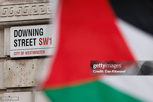 Palestinian flag flies in front of Downing Street as the prime minister convened an emergency cabinet meeting to discuss his government's policies on...
