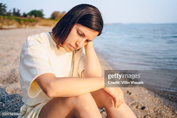 sadness woman on the sea - depressie stockfoto's en -beelden
