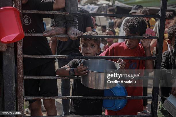 Crowds form as Palestinians receive food distributed by a charity amid the ongoing Israeli blockade and attacks on Gaza, on August 3, 2025. As Gaza...