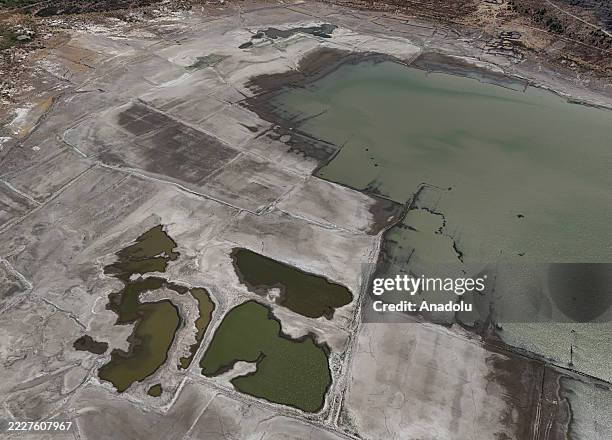 An aerial view shows the old Izmir-Cesme highway re-emerging at the Alacati Kutlu Aktas Dam, as water levels drop due to drought in Izmir, Turkiye on...