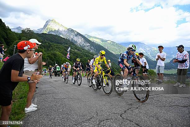 Supporters applaud as Overall leader's yellow jersey Team Visma | Lease a Bike's French rider Pauline Ferrand-Prevot climbs the Joux Plane pass...