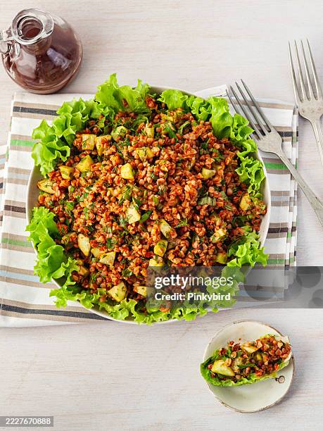 buckwheat salad. buckwheat kisir. white bowl with boiled buckwheat and lettuce on a white background. healthy homemade vegan food. buckwheat tabbouleh salad. traditional middle eastern or arab dish. levantine vegetarian salad. - tabbouleh stock pictures, royalty-free photos & images