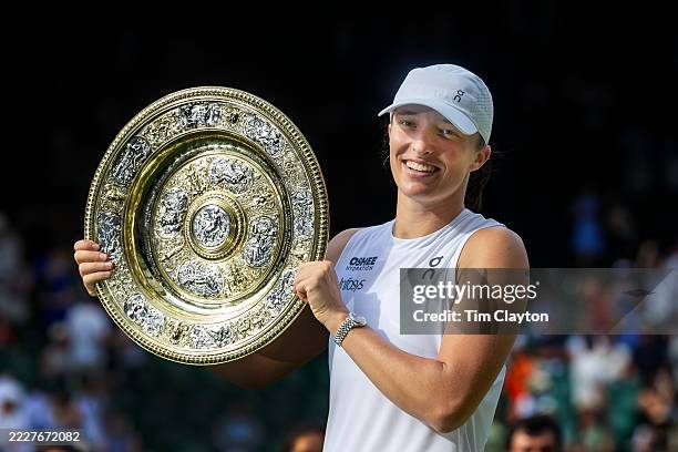 Iga Swiatek of Poland with the winners' trophy after her victory against Amanda Anisimova of the United States in the Women's Singles Final on Centre...