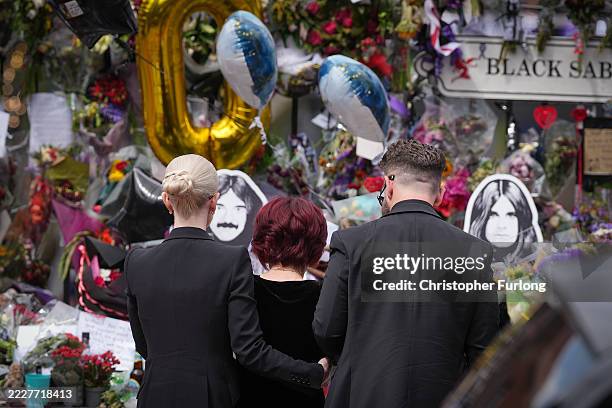 Kelly Osbourne, Sharon Osbourne and Jack Osbourne stop to view tributes to the late Ozzy Osbourne from fans at Black Sabbath Bench and Bridge as his...