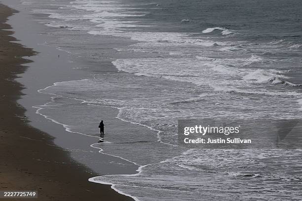 Fisherman stands in the water as he fishes during a tsunami advisory at Ocean Beach on July 30, 2025 in San Francisco, California. Authorities are...