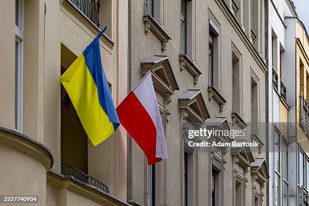 Ukrainian and Polish flags displayed on a townhouse facade, symbolizing support, brotherhood, and friendship between nations