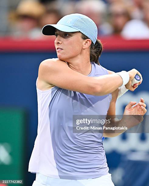 Iga Swiatek of Poland follows through with a forehand against Clara Tauson of Denmark during their fourth round singles women's match on Day Eight of...