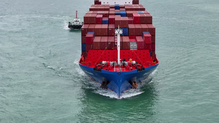 https://media.gettyimages.com/id/2227759704/video/aerial-side-view-of-cargo-ship-carrying-container-and-running-for-export-cargo-yard-port-to.jpg?b=1&s=640x640&k=20&c=F_6yNDSgAUMwQEGHJYD6GXxBnkkkcUcqhscprO_b1b0=