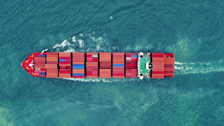https://media.gettyimages.com/id/2227761327/video/aerial-side-view-of-cargo-ship-carrying-container-and-running-for-export-cargo-yard-port-to.jpg?b=1&s=640x640&k=20&c=J6XfU6z9glIjX4Wte5AtvQsTXb4y_N61roXE3Z_xjBk=