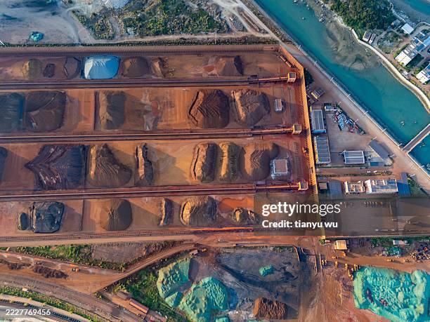 aerial view of industrial ore seaside storage yard in different colors - iron ore stock pictures, royalty-free photos & images