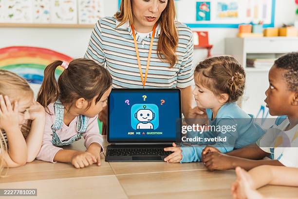 elementary student using digital tablet in class - robot teacher stock pictures, royalty-free photos & images