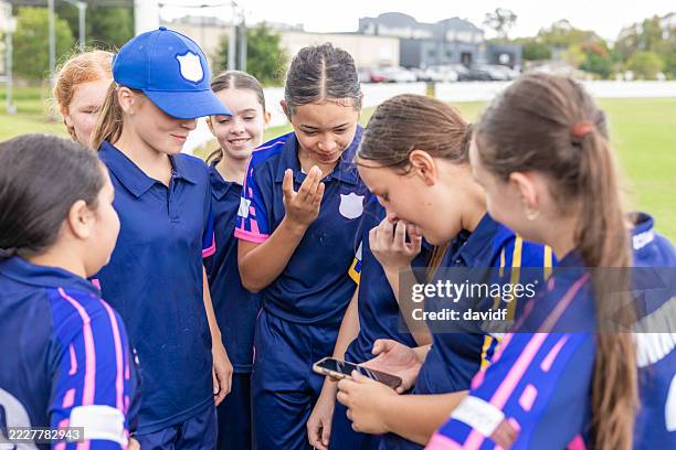 teenage girl cricket players taking a break - cricket team stock pictures, royalty-free photos & images