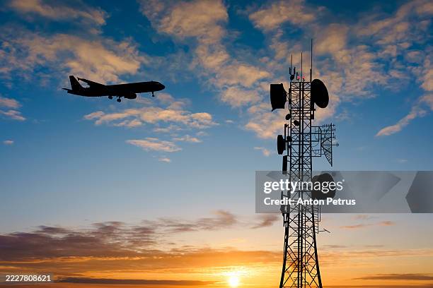 connection tower and airplane at sunset. roaming while traveling - radio wave stock pictures, royalty-free photos & images