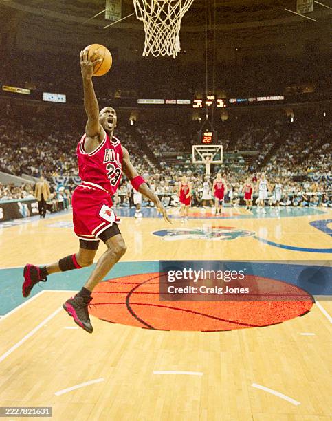 Michael Jordan, Shooting Guard and Small Forward for the Chicago Bulls in mid air driving to make a lay up shot to the basket during Game 4 of the...
