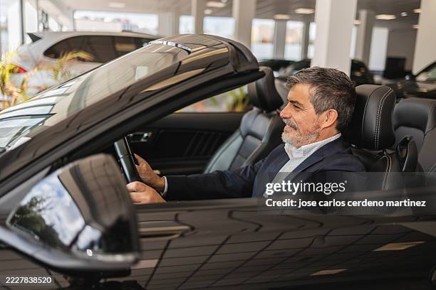 mature man enjoying luxury convertible car experience - interior de carro imagens e fotografias de stock