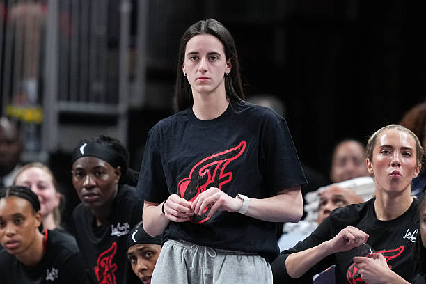 Caitlin Clark of the Indiana Fever looks on from the bench in the first quarter against the Phoenix Mercury at Gainbridge Fieldhouse on July 30, 2025...