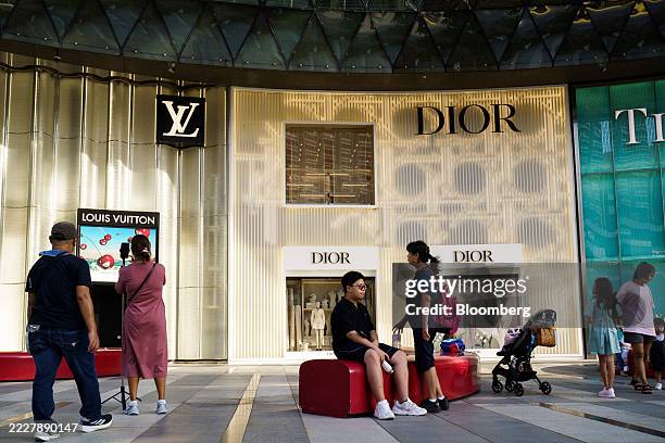 Moet Hennessy Louis Vuitton SE store, left, and a Christian Dior SE store at the Ion Orchard shopping mall along Orchard Road in Singapore, on...