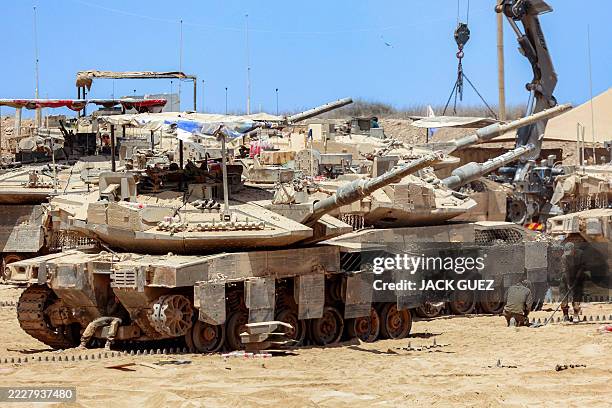 Israeli army main battle tanks are positioned near the border with the Gaza Strip in southern Israel on August 5, 2025. Israel's Prime Minister...