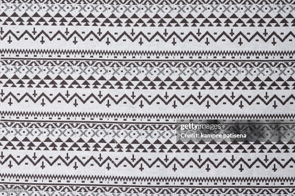 A white and black striped fabric with a pattern of triangles